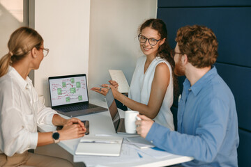 Businesspeople working together in modern coworking sitting at desk. Teamwork concept