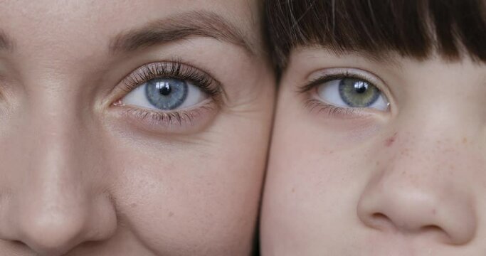 Mother And Daughter Looking Into The Camera Opening And Closing Eyes