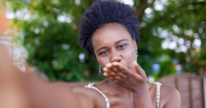 Young woman blowing a kiss at a video call