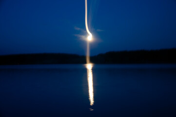UFO over the lake at night blur
