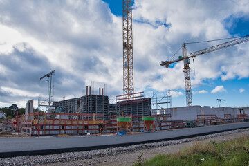 Fototapeta na wymiar Construction site with high construction crane for building houses