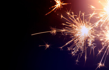 sparkling from fireworks. Background for New Year's celebrations, banner design. on the dark blue night sky