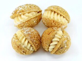 Delicious walnut shaped Christmas cookies with caramel filling on white background 