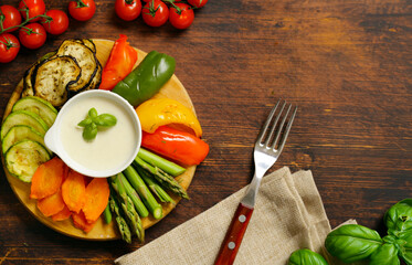 vegetables with yoghurt dip on wooden board