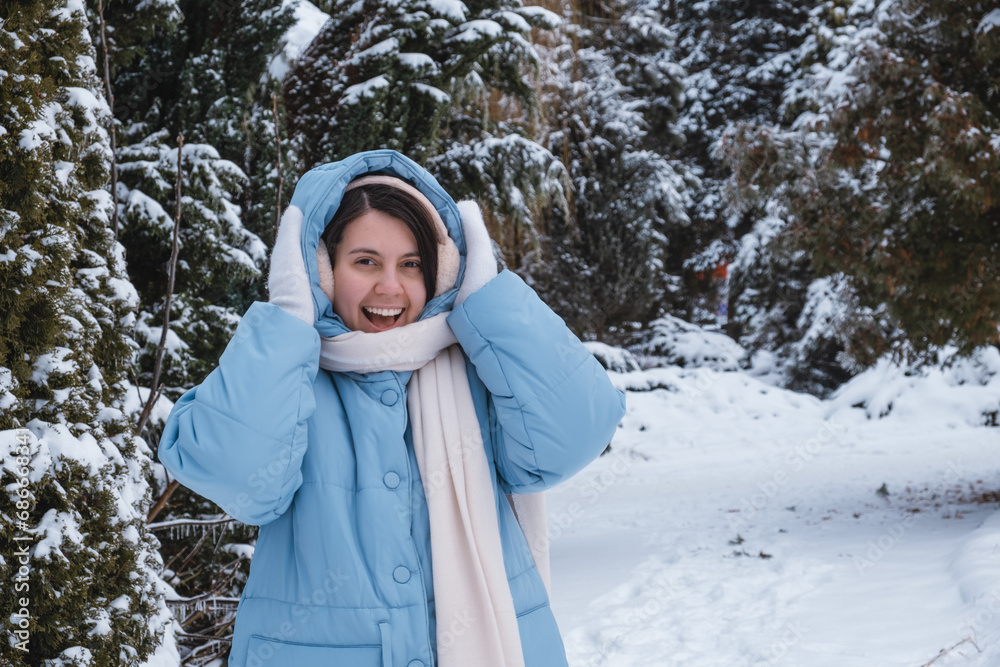 Poster portrait of happy beautiful woman outside at cold winter day