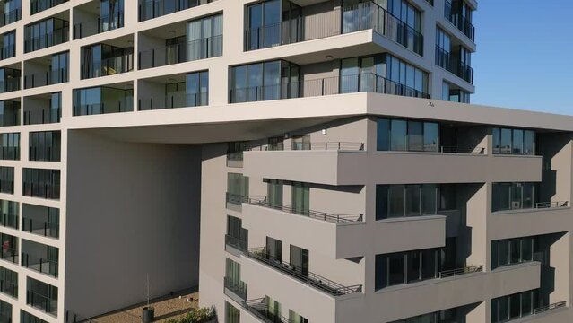Drone flight along the facade of a modern office or residential building background