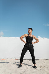 Good looking and muscular young cuban man in black and stylish outfit in Miami, south beach