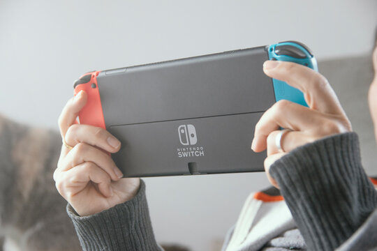 Barcelona, Dec 1st 2023: Young woman playing with a Nintendo Switch portable console.
