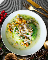 Ceviche with cockles and avocado. Christmas food served on a table decorated with Christmas motifs.