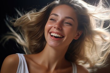 Fototapeta premium A woman with long hair is captured smiling for the camera. This image can be used to convey happiness, positivity, and confidence. It is suitable for various projects and designs