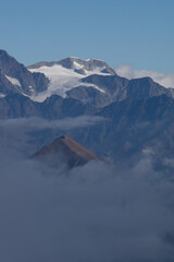 The Valtellina mountains shrouded in fog, taken from Val Madre, a small valley near the town of...