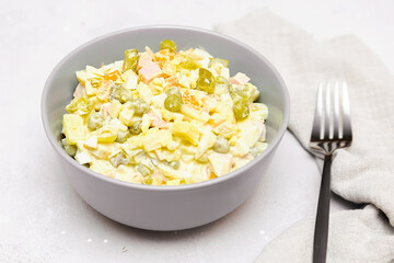Olivier salad,Christmas food.salad with chicken and vegetables,pea.Traditional ukrainian slavic appetizer for celebrating new year's eve. Festive table setting