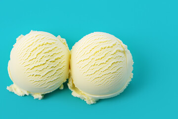 Scoops of vanilla ice cream on a light blue background.