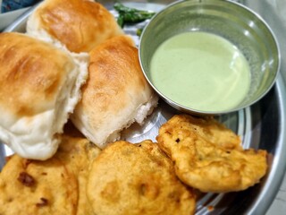 Delicious Vadapav breakfast meal on a plate, close-up and appetizing.