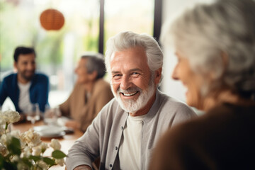 An elderly man smiles at a gathering. The concept captures senior enjoyment.