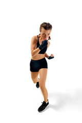 Powerful boxer girl in shorts and gloves striking pose against white studio background. Strength...