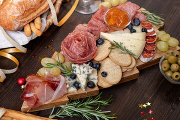 Party charcuterie board italian food antipasti prosciutto ham, salami and cheese appetizers served in the shape of a Christmas tree. party food for New Year's Eve, Christmas or birthday