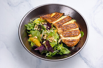 Delicious salad with chicken, orange and arugula