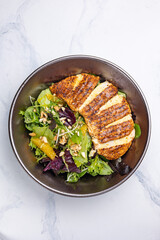 Delicious salad with chicken, orange and arugula