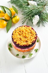 Christmas layered vegetable salad with herring and boiled vegetables