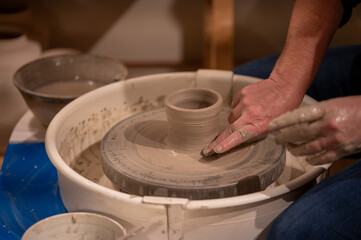 Potters wheel with hands forming clay to art