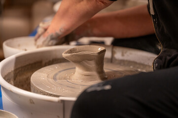Potters wheel with hands forming clay to art