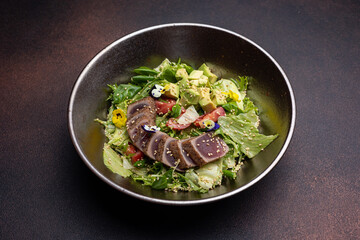 Delicious salad with tuna, avocado and arugula
