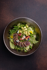 Delicious salad with tuna, avocado and arugula
