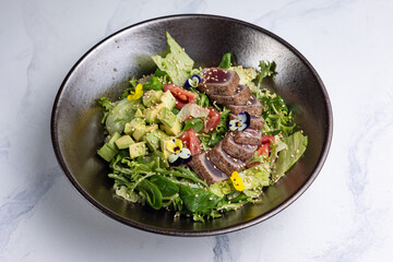 Delicious salad with tuna, avocado and arugula