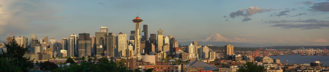 Seattle Skyline panorama with iconic landmarks and volcano at sunset