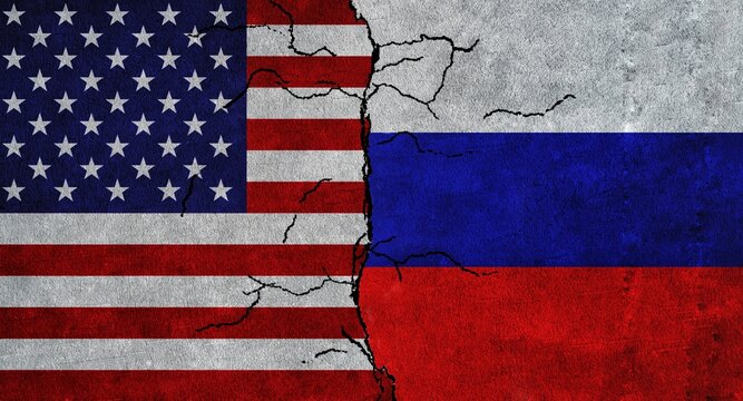 USA and Russia painted flags on a wall with grunge texture. USA-Russia conflict. United States of America and Russia flags together