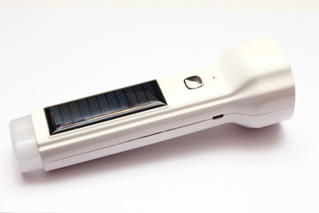 Close-up view of a solar cell flashlight on a white background.