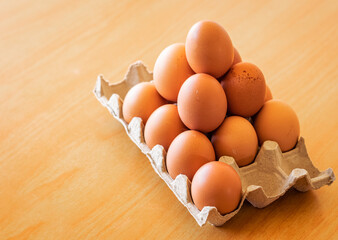 Eggs in a gray container,  holding afresh organic egg