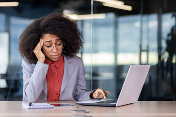 Sick woman at workplace, business woman with throbbing headache working sitting inside office with...