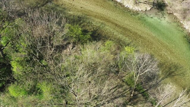 Aerial footage of river and trees in early spring. Bruckmühl, Bavaria, Germany
