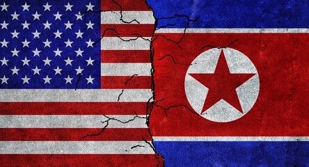 Obraz premium USA and North Korea flag together on a cracked wall. North Korea and United States of America diplomatic relations