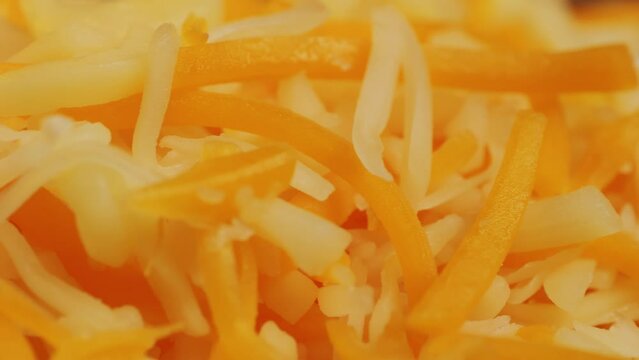 Some different sorts of grate cheese on plate close up macro. Chef grating cheese mozzarella, cheddar for meals. Itallian food, pizza, pasta. 