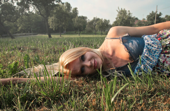portrait of young woman lying on grass