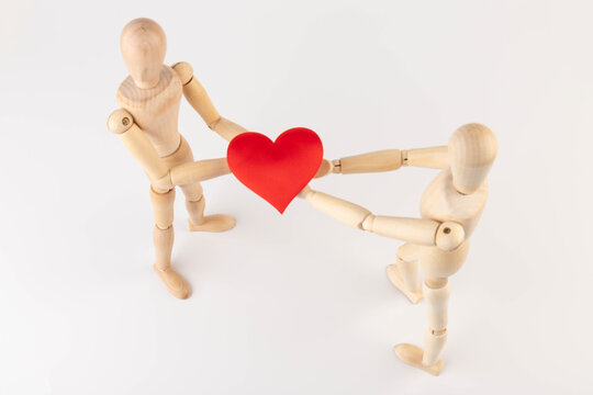 Couple of wooden mannequin figures with heart. Love and dating concept
