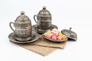 Turkish Coffee with Turkish Delight on authentic metal plate, isolated on white background