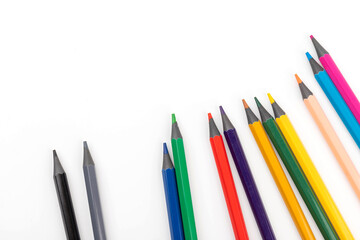 Wooden color pencils arranged in row on white isolated background. Selective focus