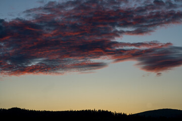Beautiful sunset in the mountains with red clouds in the sky.