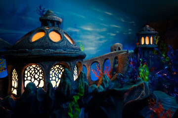 Lantern stone light up in underwater world with pink coral reef, green seaweed, plant life and...