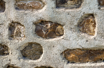 Ancient handcrafted stone wall. Close-up view of original brickwork. Typical architecture of Rome empire. Nature stone wall in Santo Stefano di Camastra, Sicily, Italy