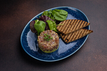Fresh Tatar on a plate. Close-up