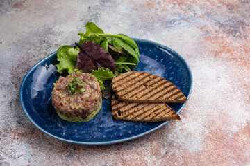 Fresh Tatar on a plate. Close-up