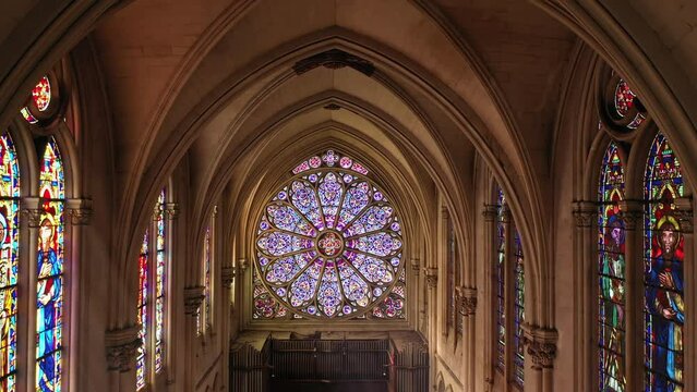 Majestic cathedral interior with a vibrant rose window.