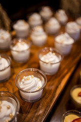 Many mousse desserts on display among other assortment of baked pastry, cakes, cookies, candies, fruits. Catering for birthday, wedding, Sunday brunch or other event