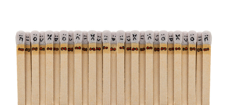 matchsticks with faces painted on the heads on white background