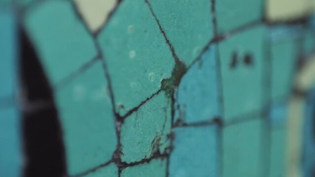 Closeup of mosaic of colored ceramic tile by Antoni Gaudi at his Parc Guell, Barcelona, Spain